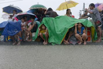 Cavite residents flee flooded homes, take shelter on street