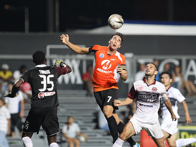 Loyola's James Younghusband (C) goes for a header against Pachanga's Steve Yambou (L) and Davide Cortina (R). James collided with the goalkeeper resulting into a penalty, converted by his brother Phil Younghusband. Photo by Mark Cristino