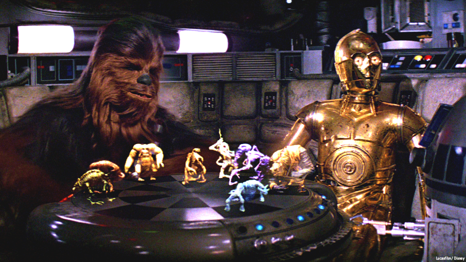 Photo shows the character played by Peter Mayhew in the Star Wars movies, Chewbacca, shown here with R2D2 playing dejarik (holochess) as C3PO looks on. FILE PHOTO