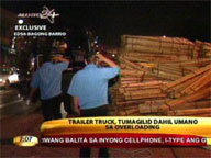 Trailer truck flips on its side due to overloading
