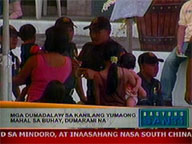 Filipinos flock to cemeteries as weather conditions improve
