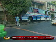 Tourist bus rams gate of apartment