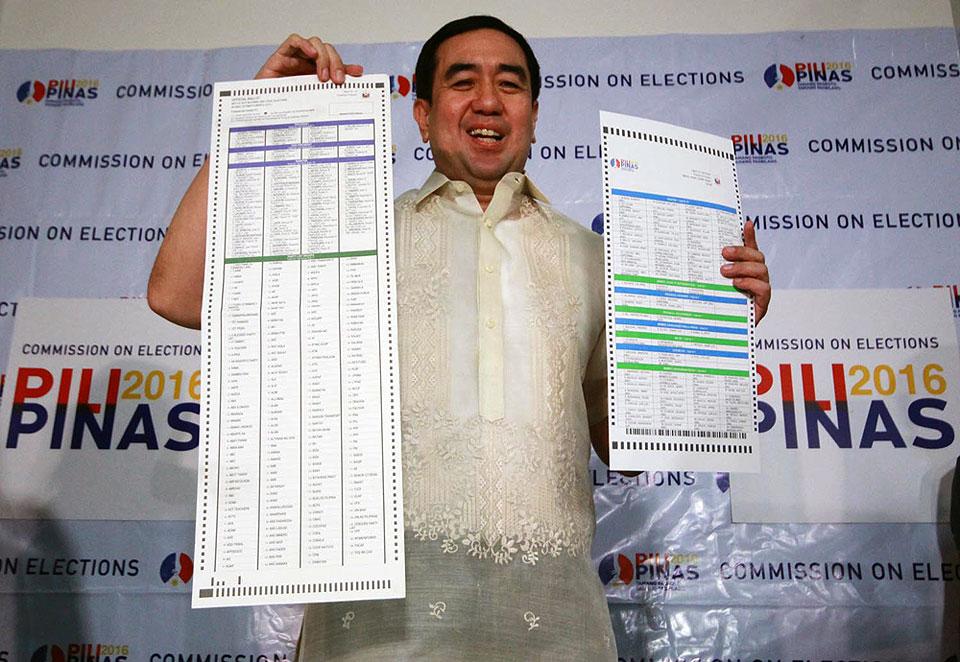 Comelec Chairman Andres Bautista compares old and new ballots. Roy Lozano