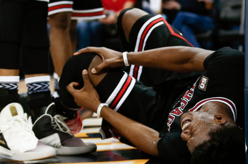 Chicago Bulls guard Jimmy Butler (21) grabs his knee after a play in the second quarter against the Denver Nuggets at the Pepsi Center. REUTERS