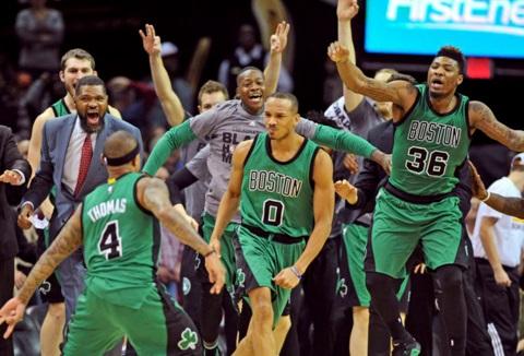 The Boston Celtics celebrate after guard Avery Bradley (0) reacts after hitting a three-point shot to end the game and beat the Cleveland Cavaliers at Quicken Loans Arena. The Celtics won 104-103. REUTERS
