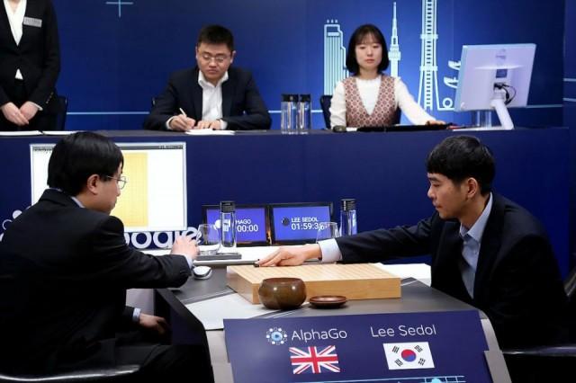 The world's top Go player Lee Sedol (R) puts his first stone during the last match of the Google DeepMind Challenge Match against Google's artificial intelligence program AlphaGo in Seoul, South Korea, in this handout picture provided by Google and released by Yonhap on March 15, 2016. REUTERS/Google/Yonhap
