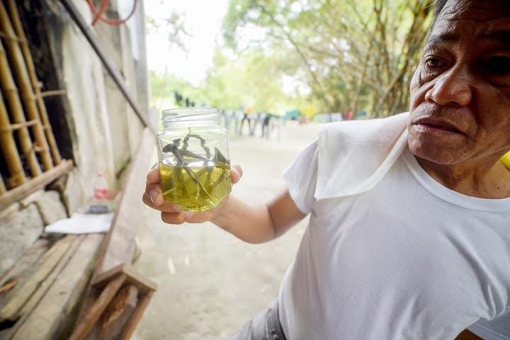 Virey uses beer to disinfect the nails used in the crucifixion ritual. RUSTON BANAL 