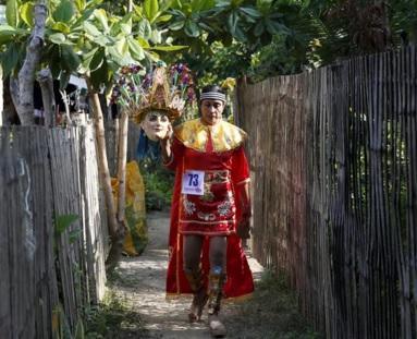 Ella Mazon carries her Morion (mask) as she walks in an alley outside her house, REUTERS