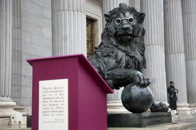 A lion statue outside Spain's parliament in Madrid, Spain, is seen fitted with glasses to celebrate Spanish writer Miguel de Cervantes' famous novel 