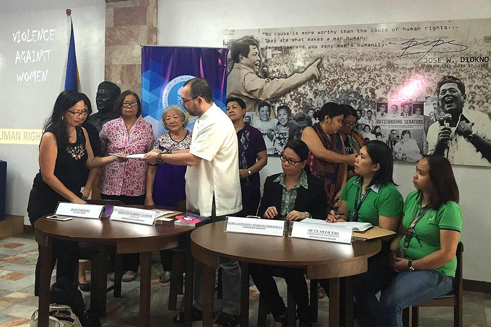 Representatives of various women's groups hand over a complaint they filed against Mayor Rodrigo Duterte to Commission on Human Rights chairman Jose Luis 'Chito' Gascon.