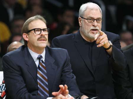 Los Angeles Lakers assistant coach Kurt Rambis (left) wears a 1970's style moustache and glasses as he sits with coach Phil Jackson during their NBA basketball game against the Boston Celtics in Los Angeles, December 30, 2007. (Xinhua/Reuters File Photo)