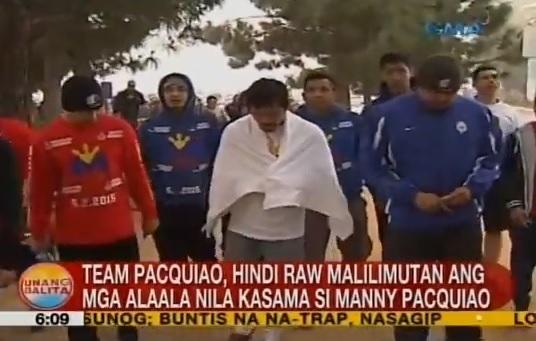 Members of Team Pacquiao walks with Manny as he cools down after training