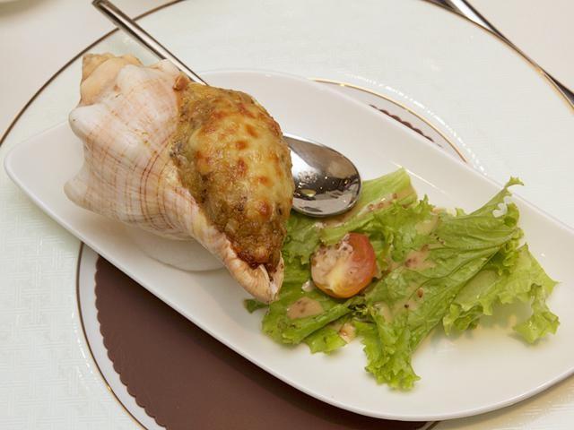 The Sea conch is mixed with rice and curry, topped with cheese, before being baked in an oven for a nice crust. Photo by Stanley Baldwin O. See.