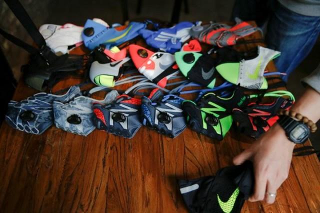 Designer Wang Zhijun arranges the face masks he made using sneakers, to be photographed in Beijing, China December 21, 2016. Photo: REUTERS/Damir Sagolj.