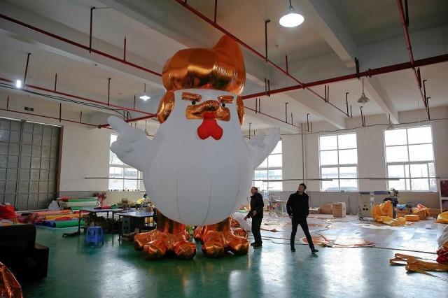 Workers show to visitors an inflatable chicken that local media say bears resemblance to US President-elect Donald Trump in Jiaxing, Zhejiang province, China January 12, 2017. REUTERS/Aly Song