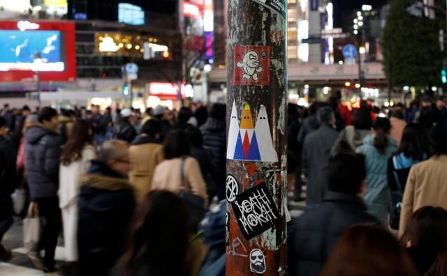 A sticker art depicting U.S. President Donald Trump, made by a Japanese graffiti artist known as 281 Antinuke, is seen at a busy crossing in Tokyo's Shibuya shopping and entertainment district, Japan, January 27, 2017. Picture taken January 27, 2017. REUTERS/Toru Hanai 