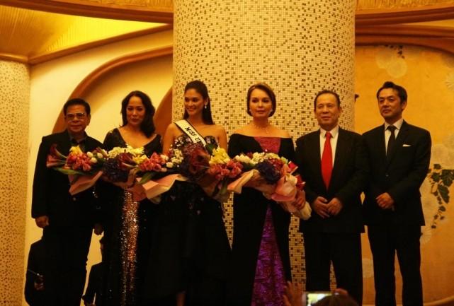 The three Filipina Misses Universe onstage with Okada executives and Chavit Singson.