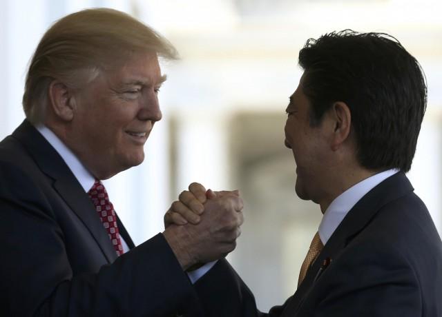 Japanese Prime Minister Shinzo Abe is greeted by U.S. President Donald Trump (L) prior to holdiing talks at the White House in Washington, U.S., February 10, 2017. REUTERS
