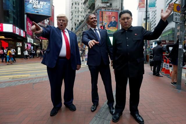 Howard (R), an Australian-Chinese impersonating North Korean leader Kim Jong-un, Reggie Brown (C) impersonating former U.S. President Barack Obama, and Dennis Alan impersonating U.S. President Donald Trump, pose in Hong Kong, China April 7, 2017. REUTERS/Bobby Yip