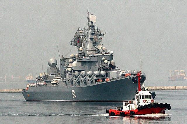 A tugboat guides the Russian Navy guided missile cruiser Varyag as it arrives at Pier 15, South Harbor, in Manila on Wednesday, April 20, 2017, for a goodwill visit. 