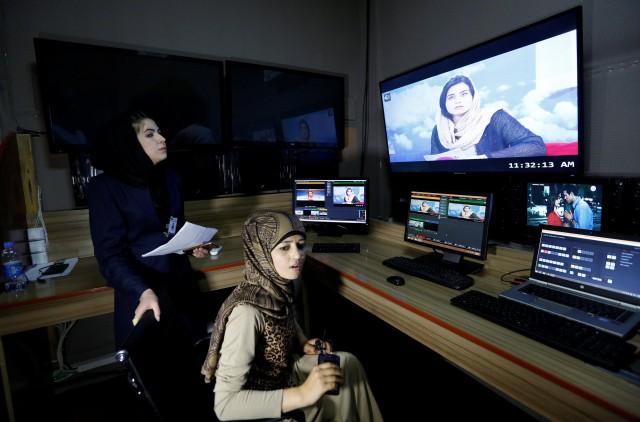 Khatira Ahmadi (R), 20, producer of Zan TV (women's TV) station, works in the editing room in Kabul, Afghanistan May 8, 2017. Picture taken May 8, 2017. REUTERS/Mohammad Ismail