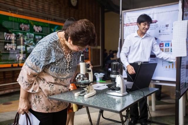  Judge Engr. Rosario Calderon of the UP ERDFI viewing miniature 3D printed objects fabricated using a new stereolithography set-up developed by Electronics and Communications Engineering student Orville M. Felicano