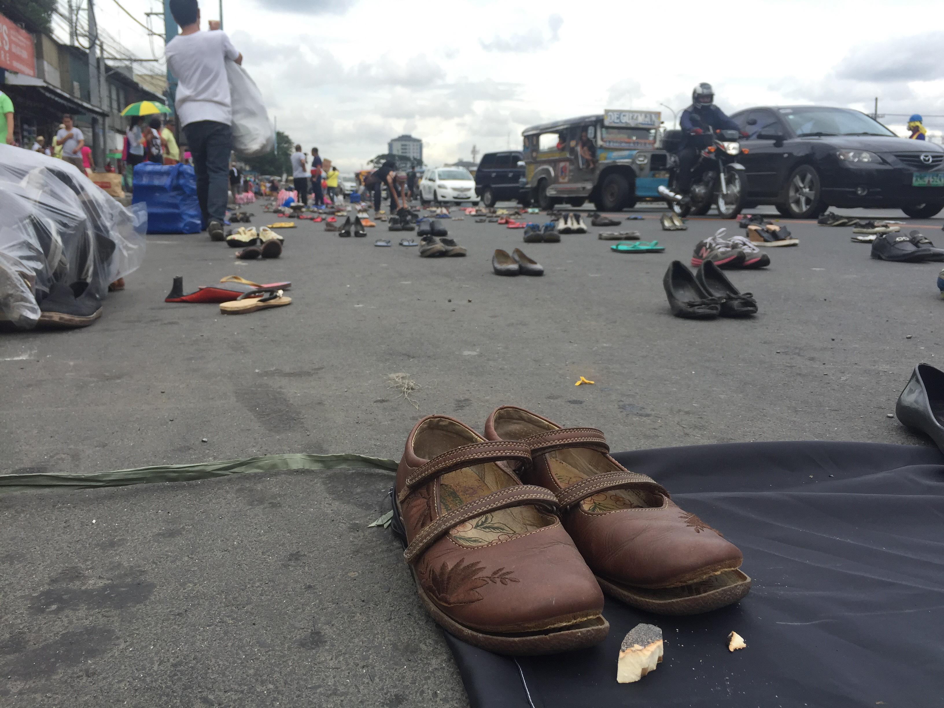 The Block Marcos Movement placed 1,000 pairs of footware along Commonwealth Avenue, symbolizing those who were supposedly killed in the campaign against illegal drugs, hours before President Rodigro Duterte delivers his second State of the National Address on Monday. Photo: Joseph Tristan Roxas, GMA News