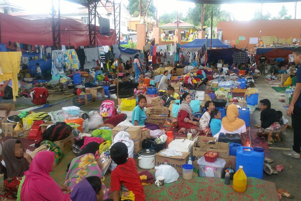 Hundreds of displaced Marawi evacuees rest on straw mats along with their clothes in plastic bags in a basketball court in Saguiaran town, Lanao del Sur on Sunday, July 2, 2017. The evacuees are struggling to maintain personal hygiene in this emergency shelter with nearly 1,500 people but only has about 12 toilets. The lack of privacy is a constant problem. MIchaela del Callar