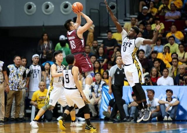 UP's Paul Desiderio going up against UST's Steve Akomo 