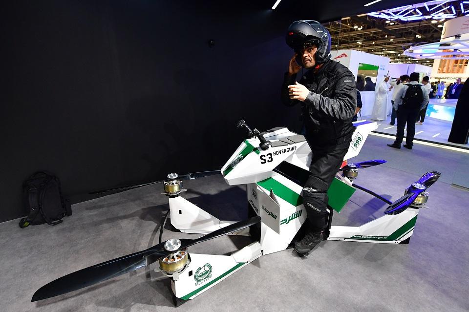 An Emiratee police officer stands next to a drone motorcycle at the Gitex 2017 exhibition at the Dubai World Trade Center in Dubai on October 8, 2017. Giuseppe Cacaci/AFP