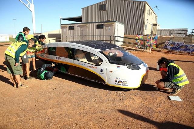 This handout from the World Solar Challenge 2017 taken and received on October 12, 2017 shows team members working on Solar Team Eindhoven vehicle Stella Vie at a control stop in Coober Pedy on the fifth day of racing. Mark Kolbe/World Solar Challenge 2017/AFP