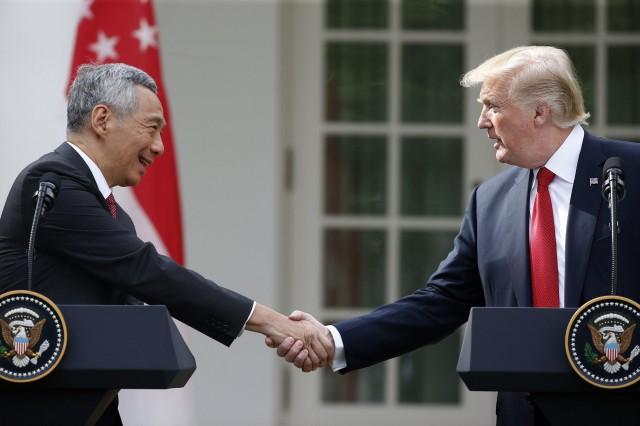 Singapore's Prime Minister Lee Hsien Loong and U.S. President Donald Trump shake hands prior to giving joint statements in the Rose Garden of the White House in Washington, U.S., October 23, 2017. REUTERS/Joshua Roberts