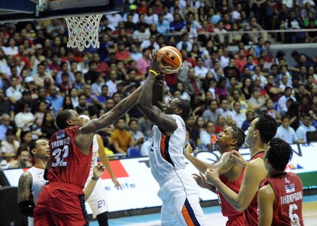 Allen Durham of Meralco forces his way to the basket against Justin Brownlee of Ginebra during their Game 3 PBA Governor's Cup Finals in Araneta Coliseum on Wednesday. PHOTO BY KC Cruz
