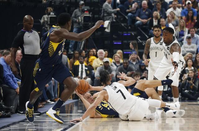 Indiana Pacers forward Bojan Bogdanovic (44) attempts to pass on the ground against Brooklyn Nets forward Ronae Hollis-Jefferson (24) and guard Jeremy Lin (7) at Bankers Life Fieldhouse. Credit: Brian Spurlock-USA TODAY Sports