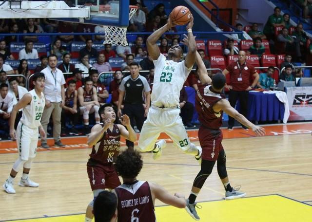 Ben Mbala of DLSU attempts a slam dunk against Juan Gomez De Liano of UP during their match in the UAAP Season 80 Basketball game in San Juan Arena on Sunday. Photo: KC Cruz