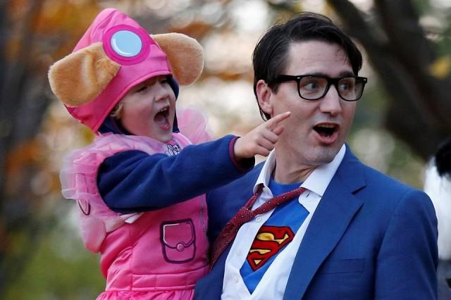 Canada's Prime Minister Justin Trudeau carries his son Hadrien while participating in Halloween festivities at Rideau Hall in Ottawa, Ontario, Canada, October 31, 2017. REUTERS/Chris Wattie