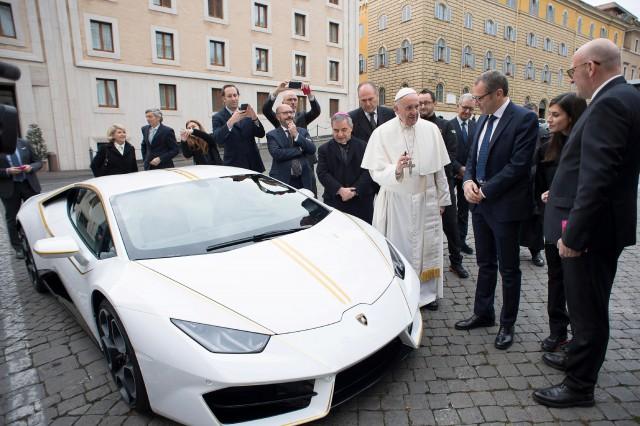 Pope Francis receives a Lamborghini Huracan prior to his Wednesday general audience in Saint Peter's square at the Vatican, November 15, 2017. Osservatore Romano/Handout via Reuters