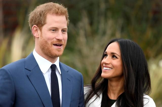 Harry and Meghan are all smiles in the Sunken Garden of Kensington Palace in London during the announcement of their engagement on November 27, 2017. REUTERS/Toby Melville