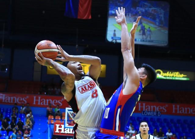 Calvin Abueva of Alaska forces his shot against Ian Sangalang of Magnolia Hotshots during their game in the 43rd PBA Philippine Cup in San Juan Arena on Wednesday.PHOTO BY KC Cruz
