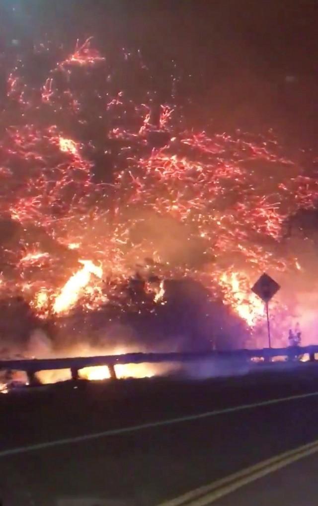 Flames of a wildfire in 405 highway in Los Angeles, California, U.S., December 6, 2017 in this picture obtained from social media. Twitter/MAJORCA @CoCo_Mayo76/Handout via REUTERS