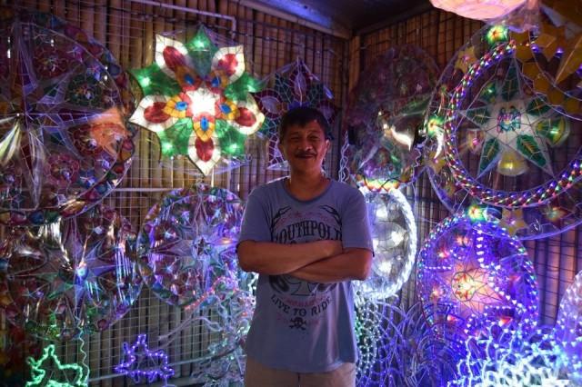 Roland Quiambao poses with smaller examples of the San Fernando parul.