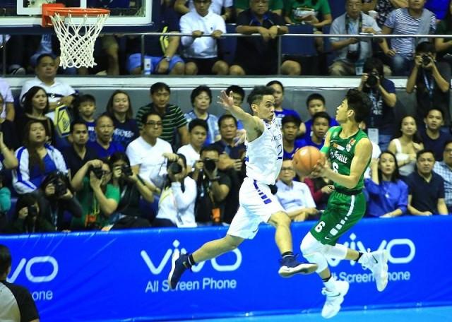 Ricci Rivero of DLSU attacks the basket against the defense of Matt Nieto of Ateneo during their game 3 Finals of the UAAP Season 80 Basketball tournament in Araneta Coliseum on Sunday. Photo by KC Cruz