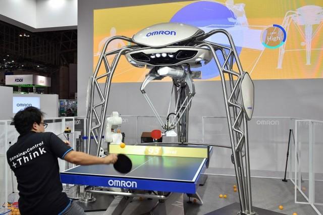 Forpheus, a fourth-generation table-tennis robot developed by automation parts maker Omron, returns a shot to a human player during a press preview at the Combined Exhibition of Advanced Technologies (CEATEC) Japan in Chiba, Tokyo on October 2, 2017. Kazuhiro Nogi/AFP
