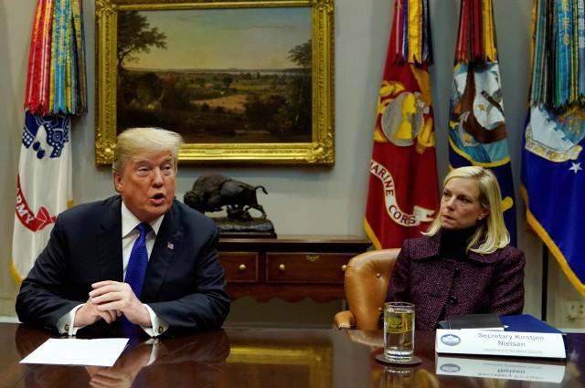 Homeland Security Secretary Kirstjen Nielsen (R) listens as U.S. President Donald Trump speaks during a meeting with Republican members of the Senate about immigration at the White House in Washington, U.S., January 4, 2018. REUTERS/Kevin Lamarque