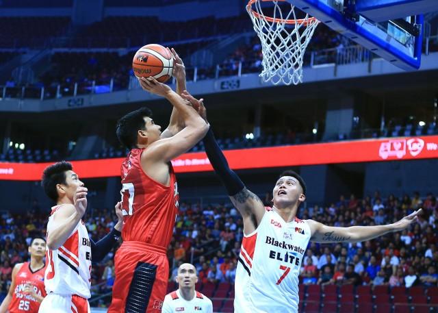 JP Erram of Blackwater tries to block the shot of Jervy Cruz of Ginebra during their game in the 43rd PBA Philippine Cup in MOA Arena on Friday.PHOTO BY KC Cruz 
