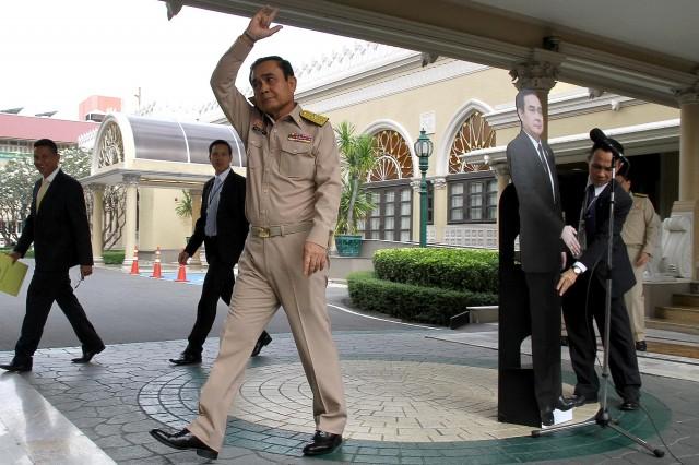 Thailand's Prime Minster Prayuth Chan-ocha waves to reporters next to a cardboard cut-out of himself at the government house in Bangkok, Thailand January 8, 2018. Picture taken January 8, 2018. Dailynews via REUTERS