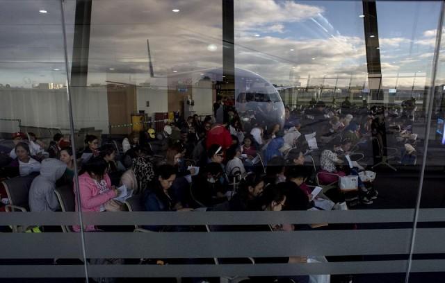 Filipina workers returning home from Kuwait fill out forms upon their arrival at NAIA on February 18, 2018. After the horrific murder Jennifer Demafelis, hundreds of such women are now streaming back home, recounting their abuse and hardship -- but also saying they are ready to work abroad again. NOEL CELIS / AFP