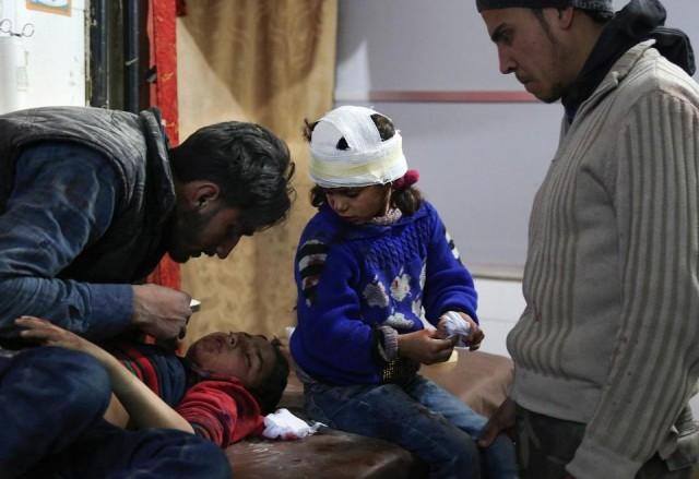 Wounded Syrian children receive treatment at a make-shift hospital in Kafr Batna following Syrian government bombardments on the besieged Eastern Ghouta region on the outskirts of the capital Damascus on February 21, 2018. Ammar Suleiman/AFP