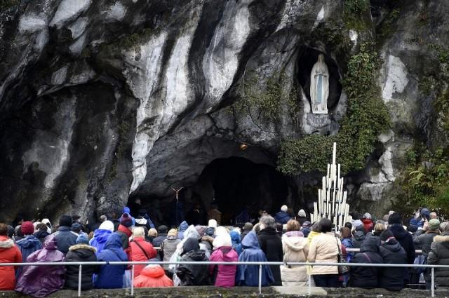 Pilgrims gather at the Massabielle grotto on February 11, 2016 for the 158th anniversary of the Marian apparitions supposedly witnessed by Bernadette Soubirous in Lourdes, France. Pascal Pavani/AFP