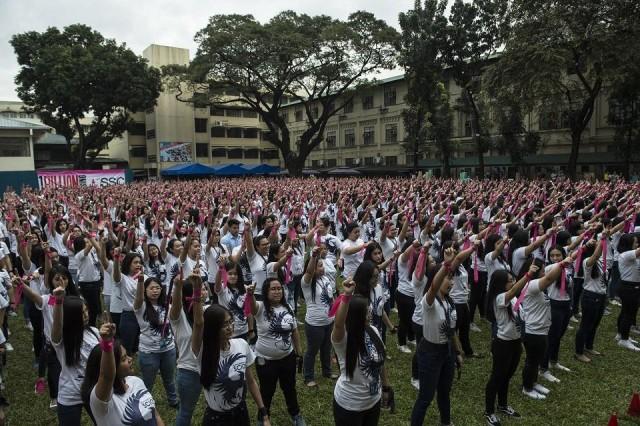 Students of St. Scholastica's College make a "number one" gesture as they dance to take part in the One Billion Rising global movement in Manila on February 14, 2018, to coincide with Valentine's Day. Ted Aljibe/AFP